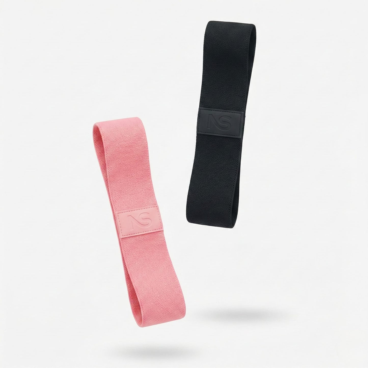 Set de deux bandes de résistance en tissu Neosweat (rose et noir) pour fitness et musculation à domicile.